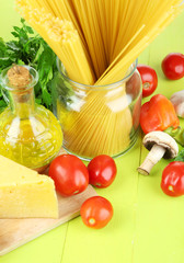 Pasta with oil, cheese and vegetables on wooden table close-up