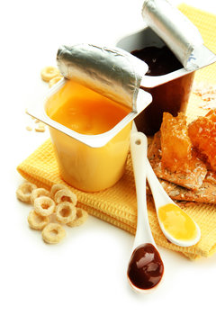 Tasty desserts in open plastic cups and honey combs, fruits,