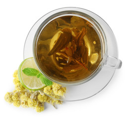 Transparent cup of herbal tea with herb isolated on white