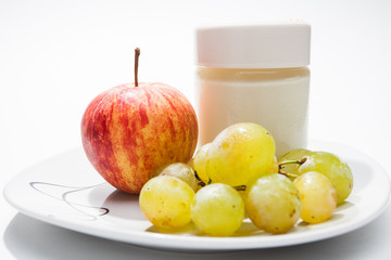 Dish with yogurt, apple and grapes