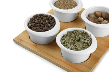 Assortment of spices in  white  bowls,
