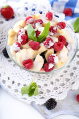 Fruit salad in glass bowl, isolated on white