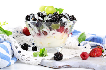 Fruit salad in glass bowl, isolated on white