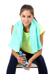 Beautiful young girl with bottle of water isolated on white