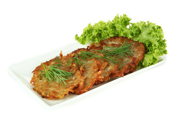 Potato pancakes on plate, isolated on white