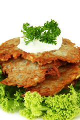 Potato pancakes on plate, isolated on white