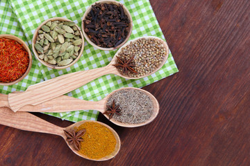 Various spices and herbs on wooden background