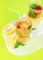 Basil lemonade with strawberry in  jug and glass,