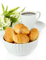 Tasty croissants and cup of coffee isolated on white