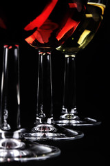 Detail of three wine glasses on dark background