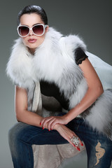 photo beautiful girl is in fashion style is in fur clothes