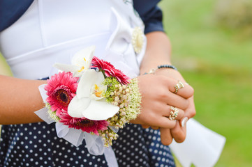 Maid of honor holding flower bouquet