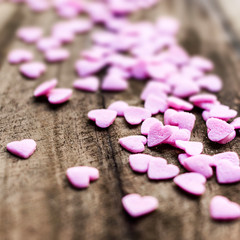 Obraz na płótnie Canvas Valentines Day background with hearts. Sugar Hearts on wooden vi