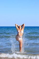 Fototapeta na wymiar Woman in bikini in the sea