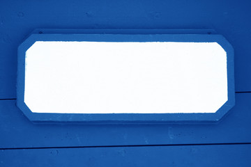 Wooden signboard on blue planks background