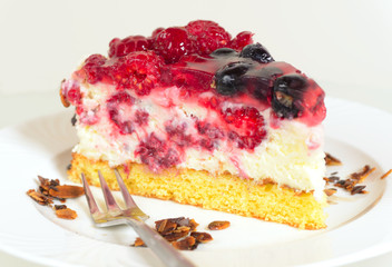piece of fresh yoghurt cheesecake with berries as a closeup image