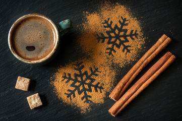 Cinnamon and a cup of coffee on a chalkboard