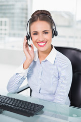 Cheerful businesswoman using headset