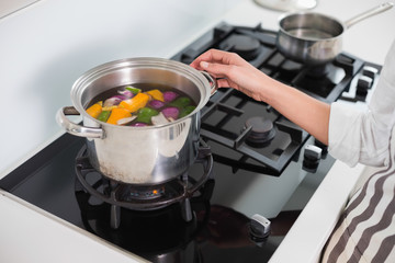 Close up on woman cooking healthy vegetables