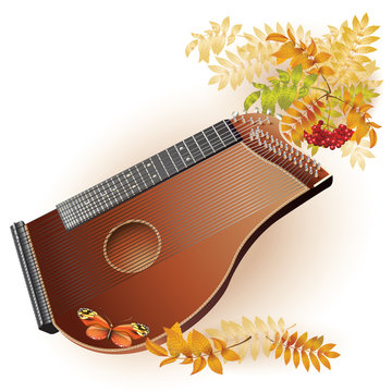 Traditional zither on white autumn background with yellow leaves