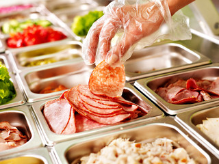 Tray with  food  on showcase at cafeteria