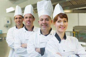 Group of happy chefs smiling at the camera