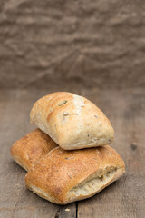 Olive bread rollis in rustic kitchen setting with utensils