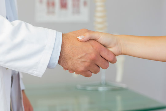 Close up of patient shaking hands with doctor