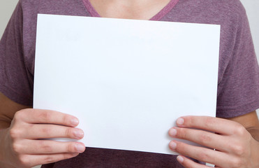 Two hands holding a white message canvas/paper