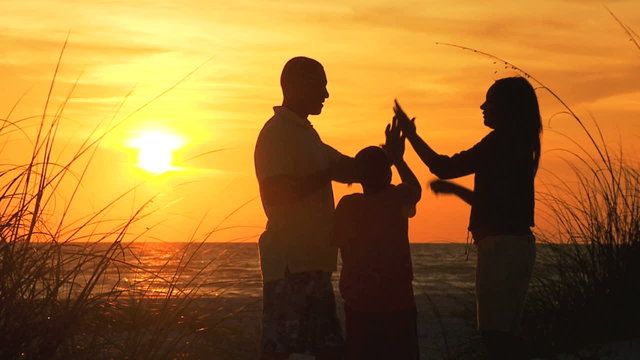 African American Family Watching Sunset Silhouette