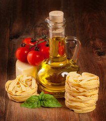 Obraz na płótnie Canvas Italian cuisine. Vegetables, oil, spices and pasta on the table