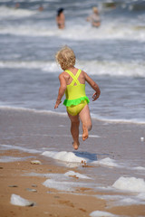 little girl running on the beach