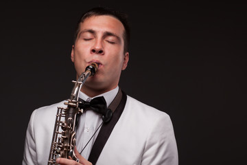 Fototapeta premium Closeup of playing saxophonist. Modern musician