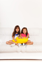 Obraz na płótnie Canvas Two happy girls with pillows