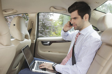 Businessman working in his car