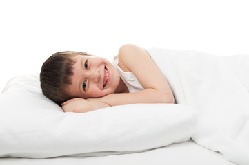Obraz na płótnie Canvas cheerful boy in white bed