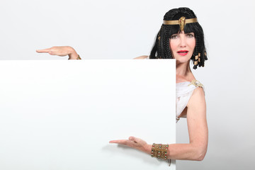 Woman dressed as Egyptian holding message board