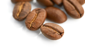 Macro of coffee beans isolated on white background