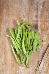 Green beans on a wooden background