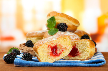 Tasty donuts with berries on wooden table