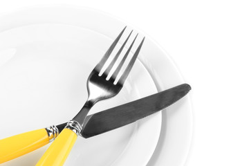 Knife, color plate and fork, isolated on white