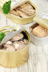 Open tin can, on wooden background
