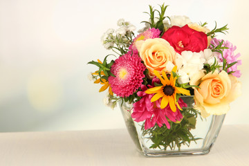 Beautiful bouquet of bright flowers in glass vase,