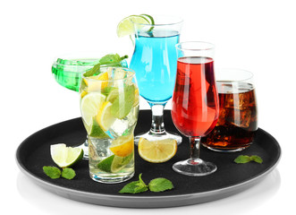 Many glasses of cocktails on tray, isolated on white