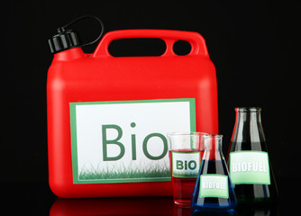 Bio fuels in canister and vials on black background
