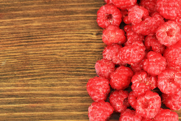 Fresh raspberry on wooden background