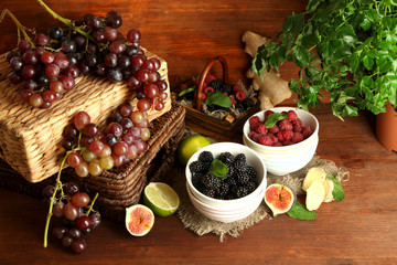 Assortment of juicy fruits and berries on wooden background