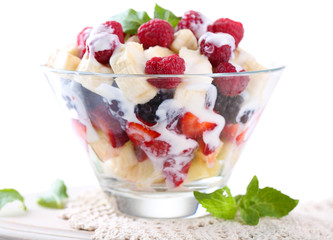 Fruit salad in glass bowl, isolated on white