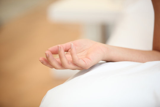 Closeup of a woman's hand on a bed