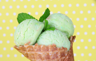 Appetizing green ice cream in waffle cone